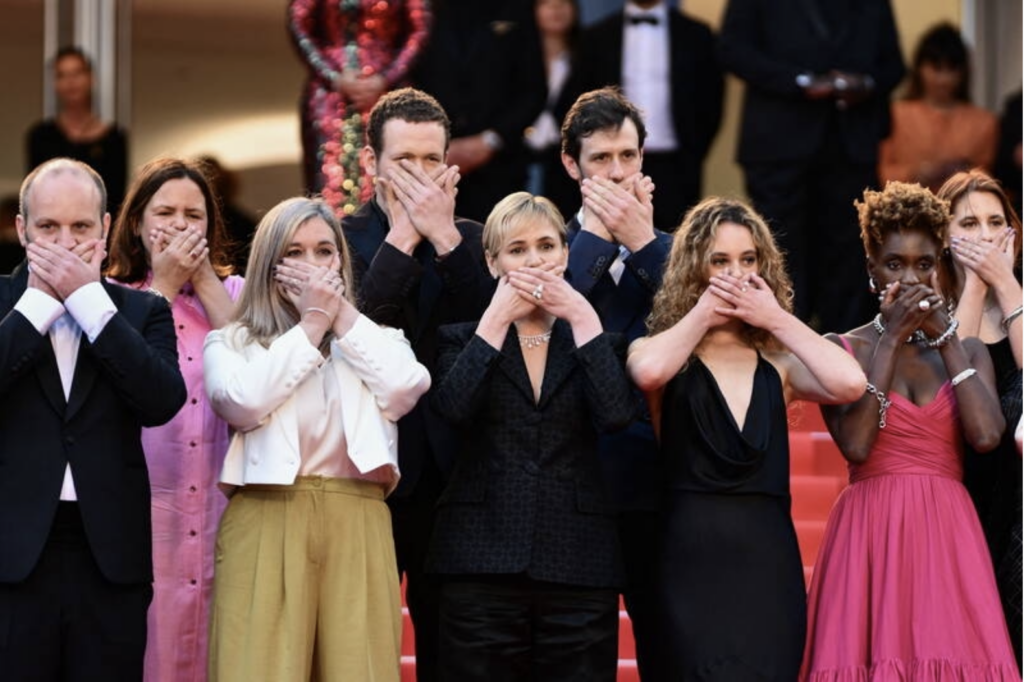 Judith Godrèche et son équipe, se couvrant la bouche avec les mains lors de l'ouverture du Festival de Cannes pour protester contre les agressions sexistes et sexuelles dans le milieu du cinéma.